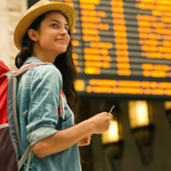 Young woman checking her train in time board